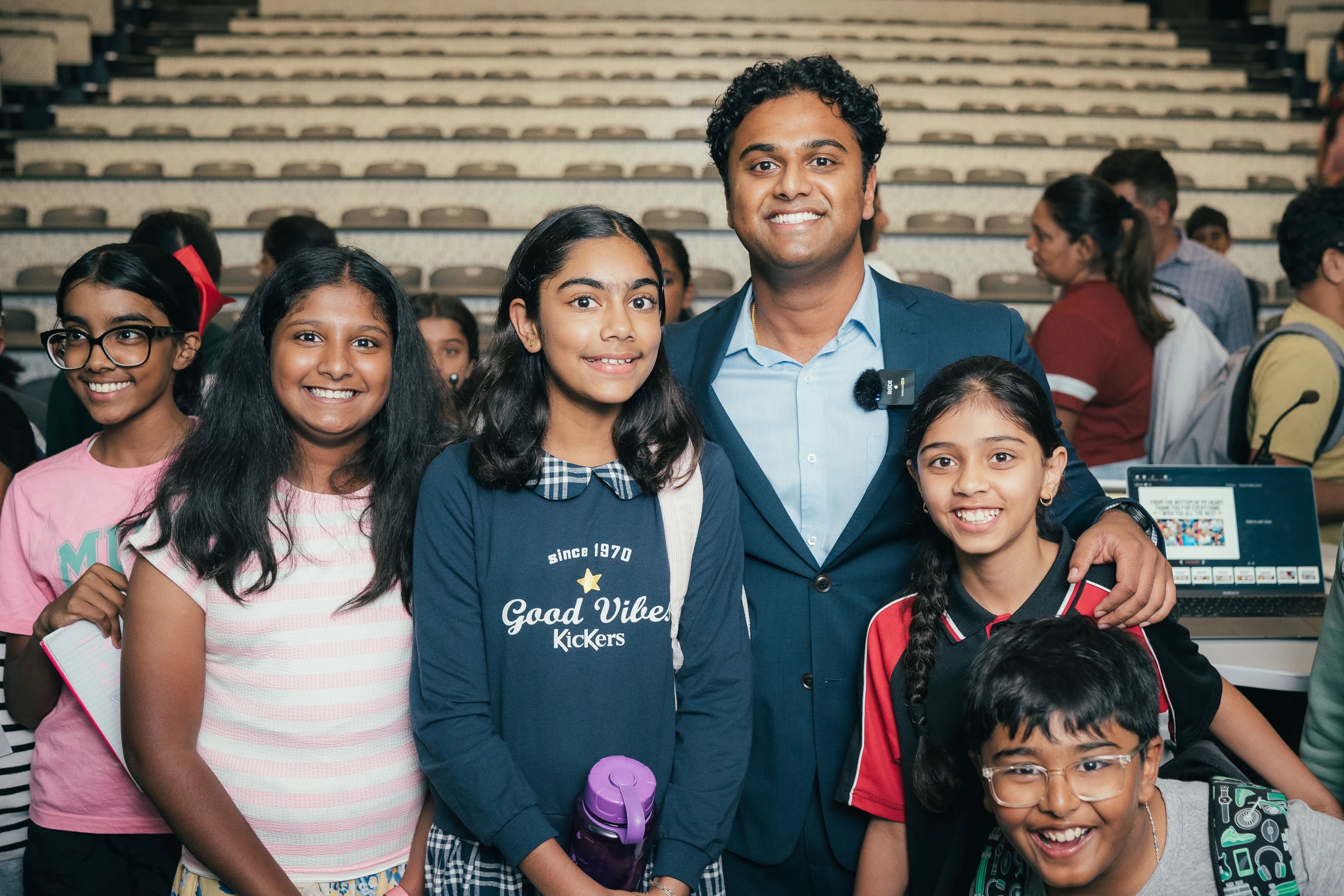 An educator and students gathered for a Loyola community photo