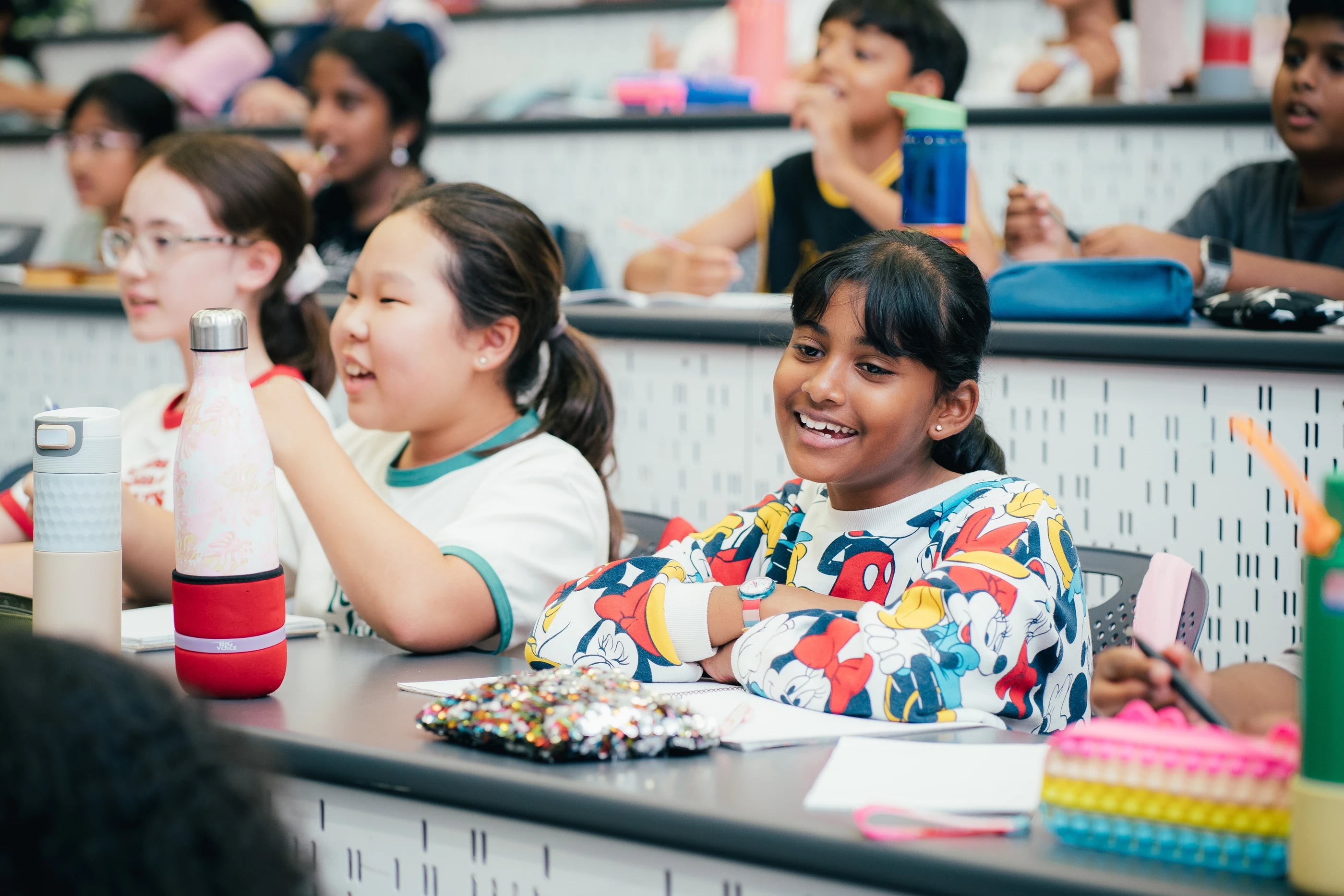 Students sharing a happy moment at their desks